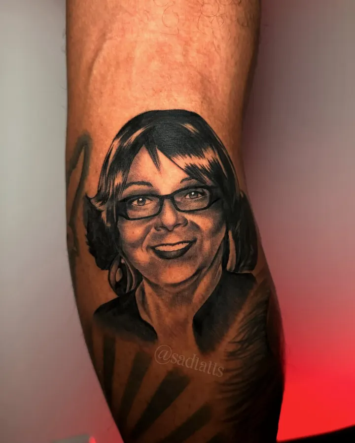 Black and grey tattoo by Dre: woman portrait, forearm
