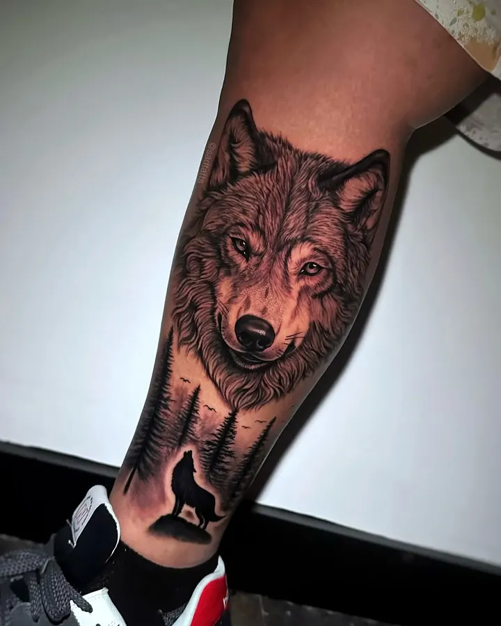 Black and grey tattoo by Dre: wolf with howling wolf, forearm
