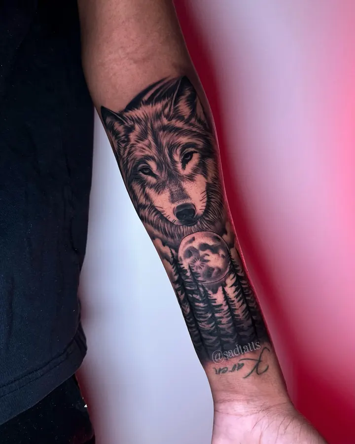 Black and grey tattoo by Dre: wolf with moon, forearm