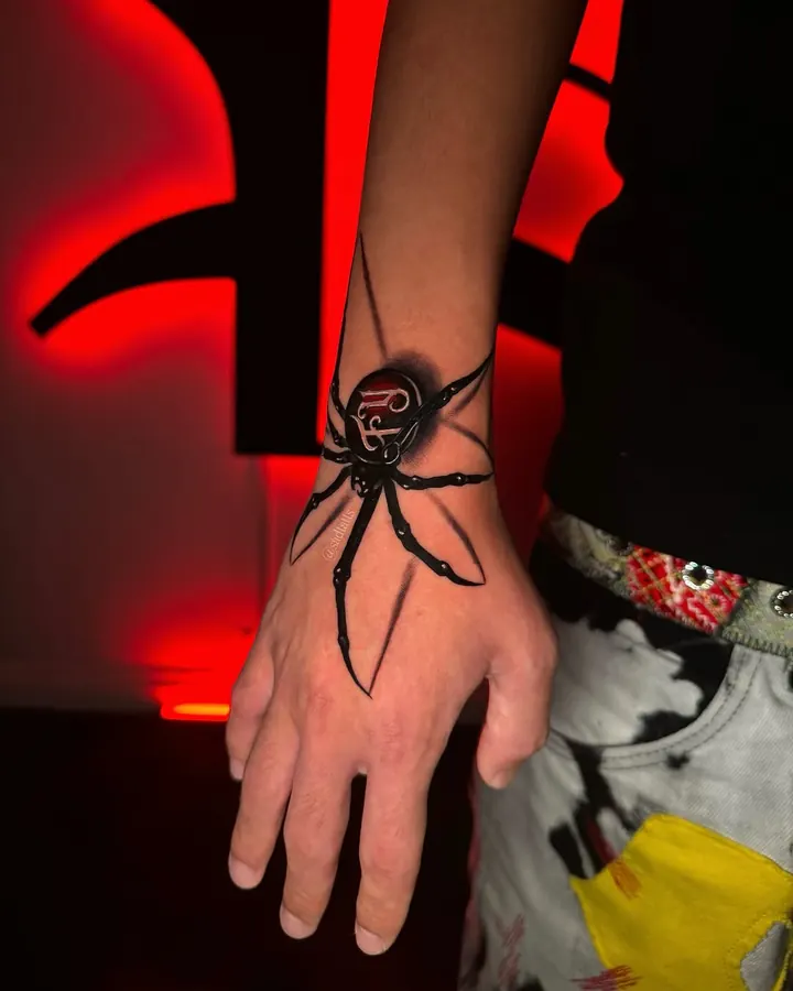 Black and grey tattoo by Dre: spider, hand