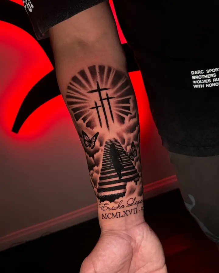 Black and grey tattoo by Dre: cross and stairs, forearm