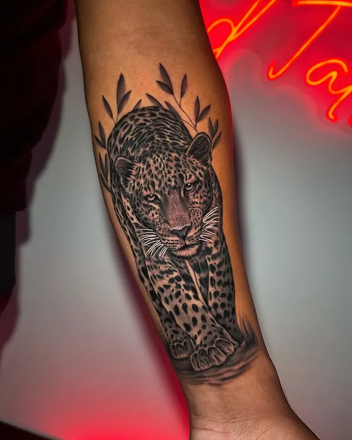 Black and grey tattoo by Dre: leopard, forearm
