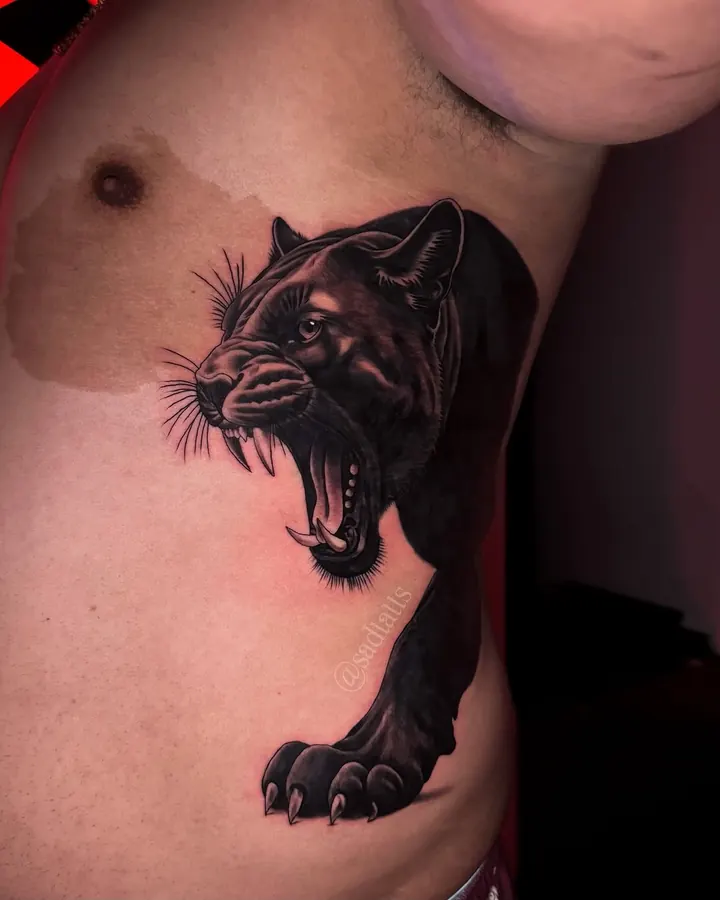 Black and grey tattoo by Dre: panther, ribs