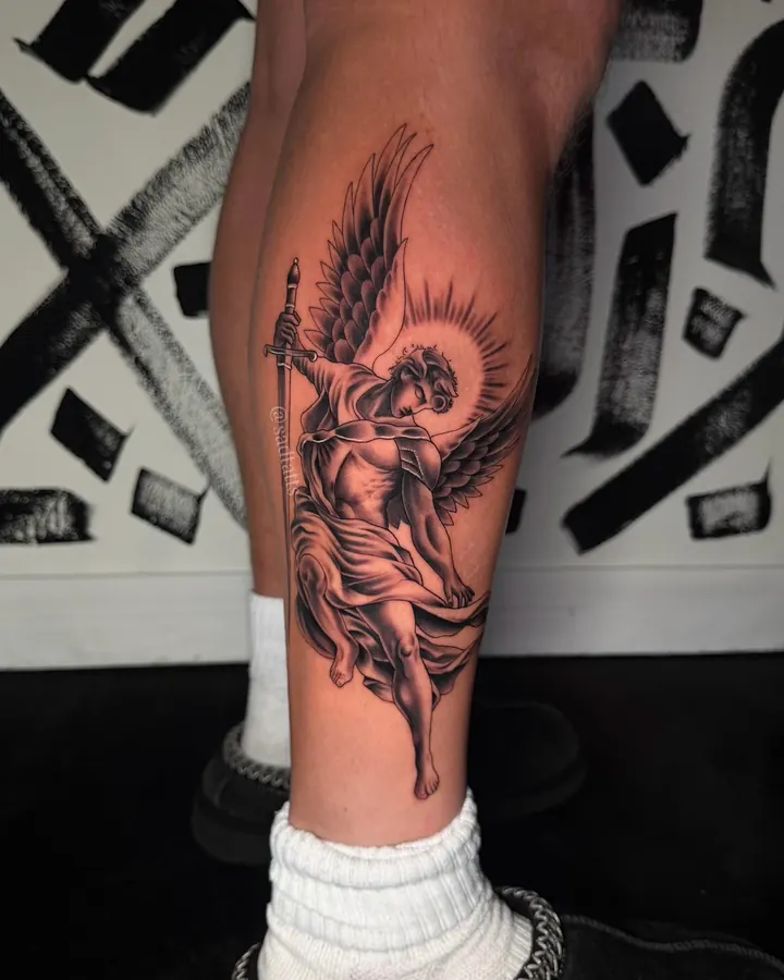 Black and grey tattoo by Dre: angel, calf