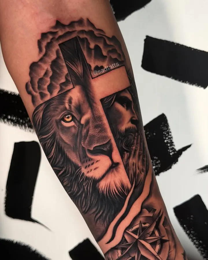 Black and grey tattoo by Dre: lion and cross, forearm