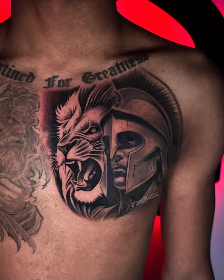 Black and grey tattoo by Dre: lion and spartan helmet, chest