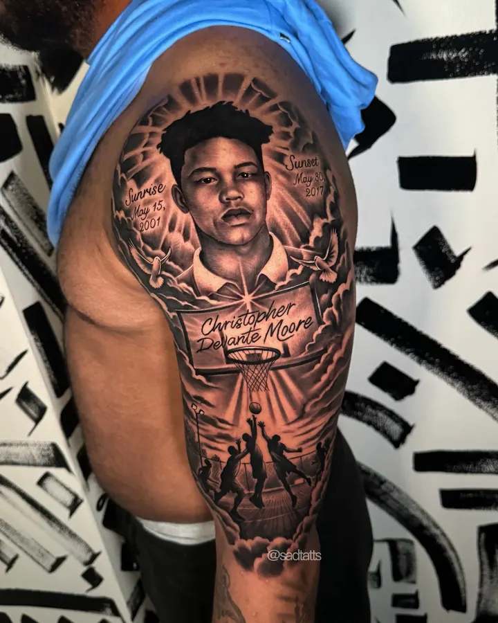 Black and grey tattoo by Dre: memorial portrait, upper arm