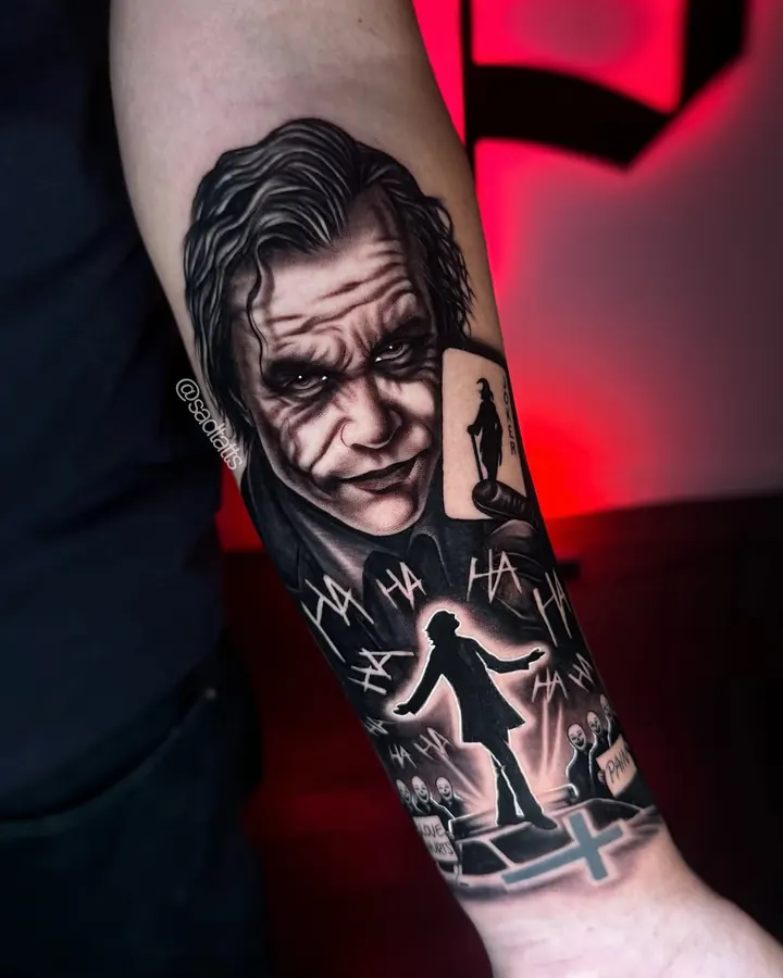 Black and grey tattoo by Dre: joker, forearm