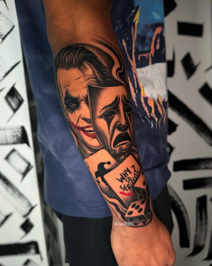 Black and grey tattoo by Dre: joker mask and dice, forearm