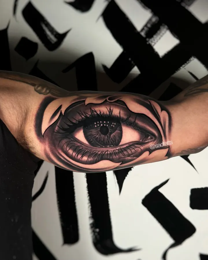Black and grey tattoo by Dre: realistic eye, forearm